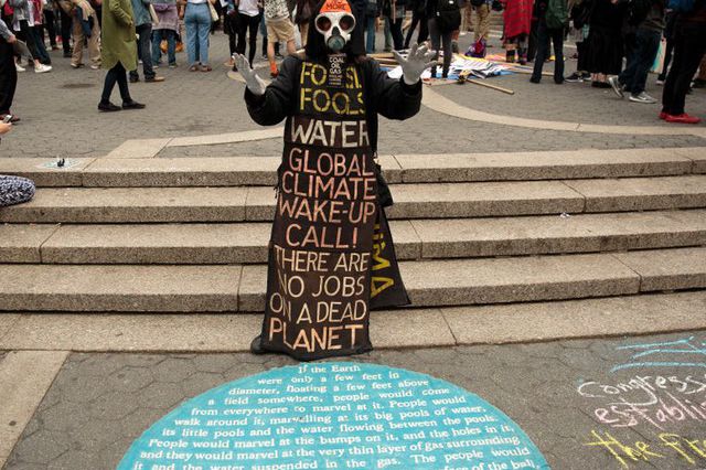 A May Day demonstrator warns against the dangers of climate change during a 2017 May Day rally in Union Square.